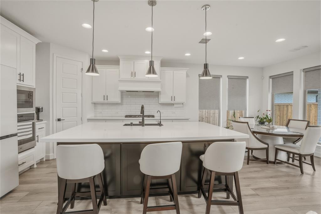 908 Maple Leaf Lane Haslet, TX 76052 - Photo 11 of 40 a large kitchen with a table and chairs