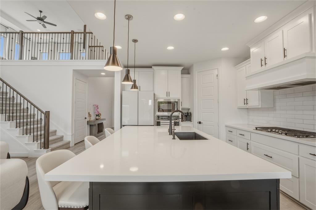 908 Maple Leaf Lane Haslet, TX 76052 - Photo 13 of 40 a large white kitchen with sink and stove