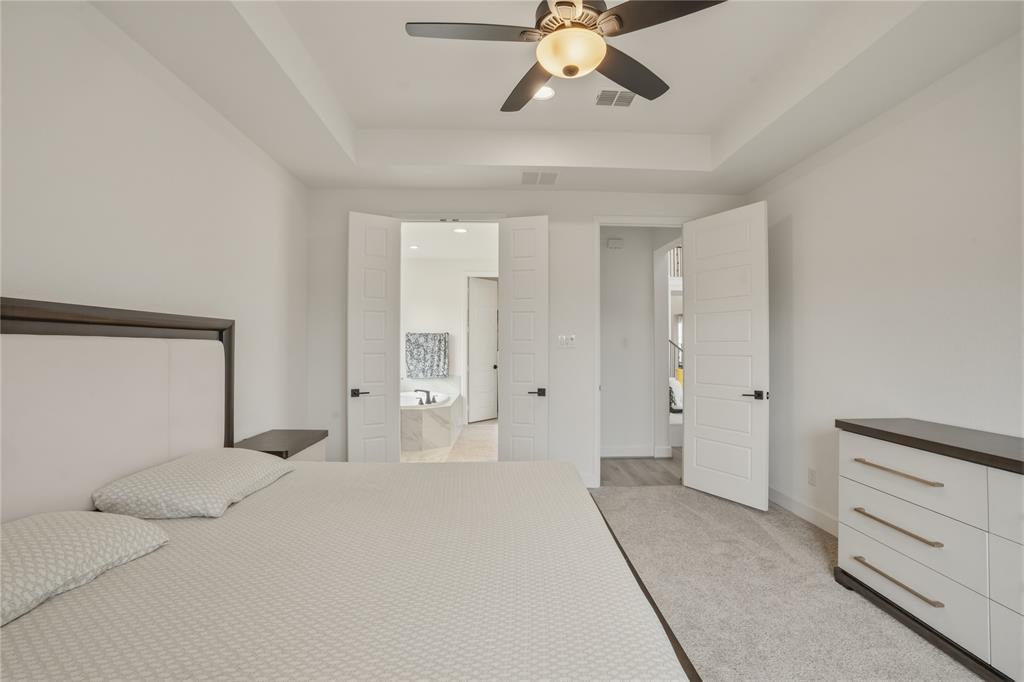 908 Maple Leaf Lane Haslet, TX 76052 - Photo 19 of 40 a view of a bedroom with closet and chandelier fan