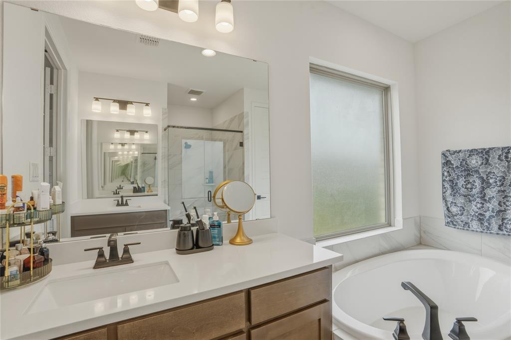 908 Maple Leaf Lane Haslet, TX 76052 - Photo 21 of 40 a bathroom with a tub sink and mirror