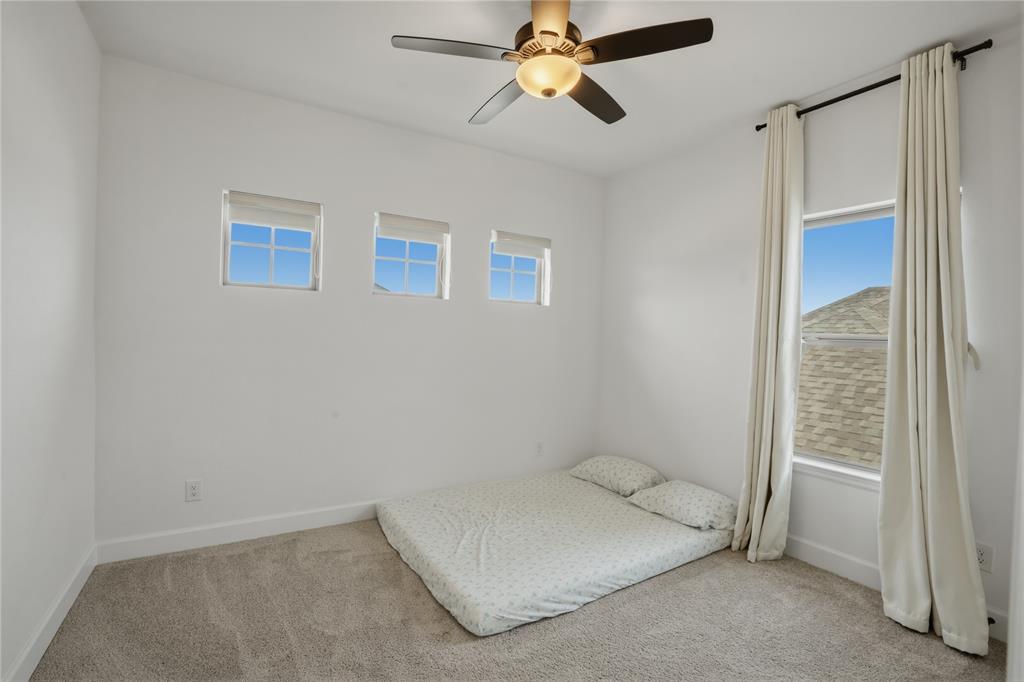 908 Maple Leaf Lane Haslet, TX 76052 - Photo 28 of 40 a spacious bedroom with a bed and a window