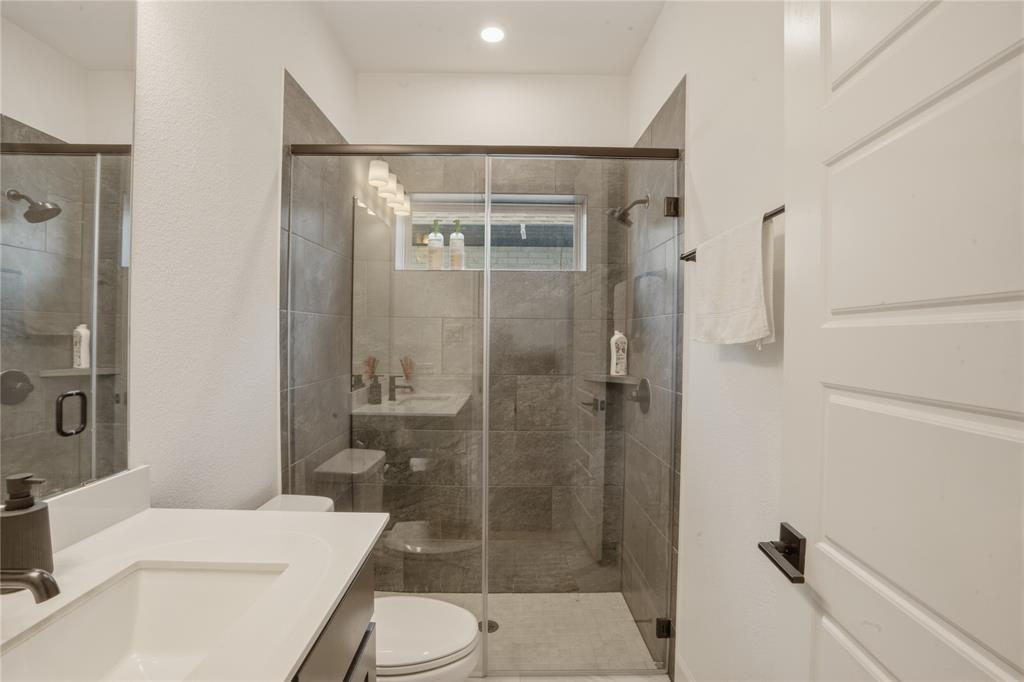 908 Maple Leaf Lane Haslet, TX 76052 - Photo 30 of 40 a bathroom with a toilet a sink and shower