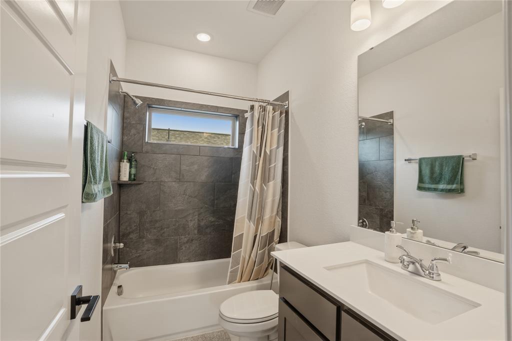 908 Maple Leaf Lane Haslet, TX 76052 - Photo 31 of 40 a bathroom with a bathtub shower sink vanity mirror and toilet
