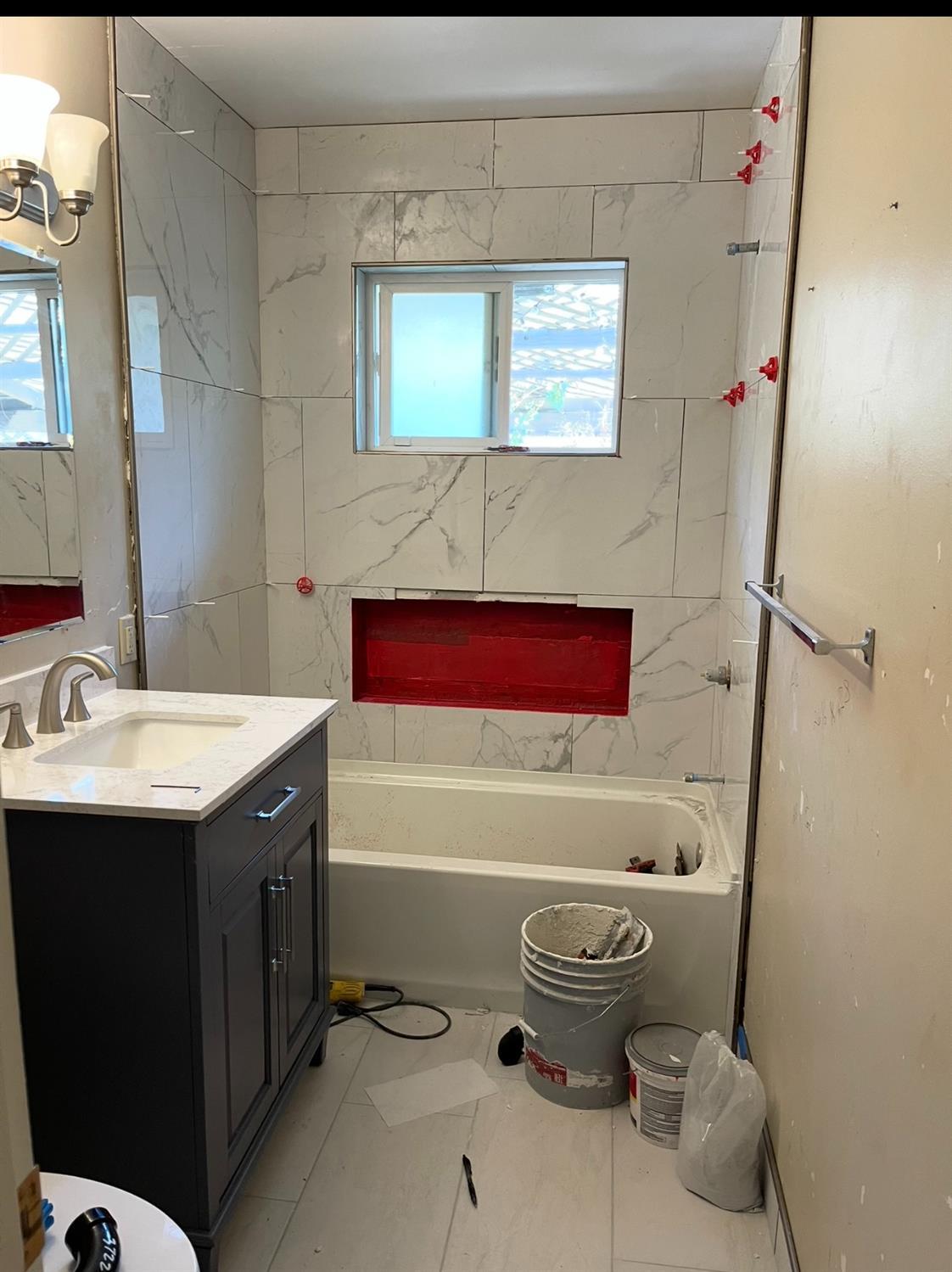 1205 F Street Reedley, CA 93654 - Photo 17 of 33 a bathroom with a sink and a bathtub