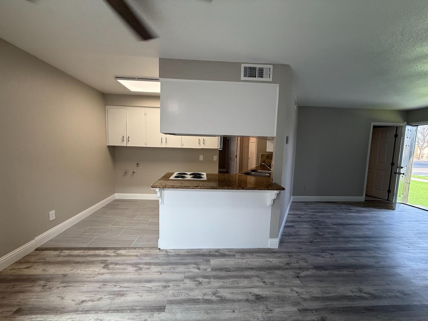 1205 F Street Reedley, CA 93654 - Photo 21 of 33 a view of kitchen with stainless steel appliances granite countertop a sink and a stove