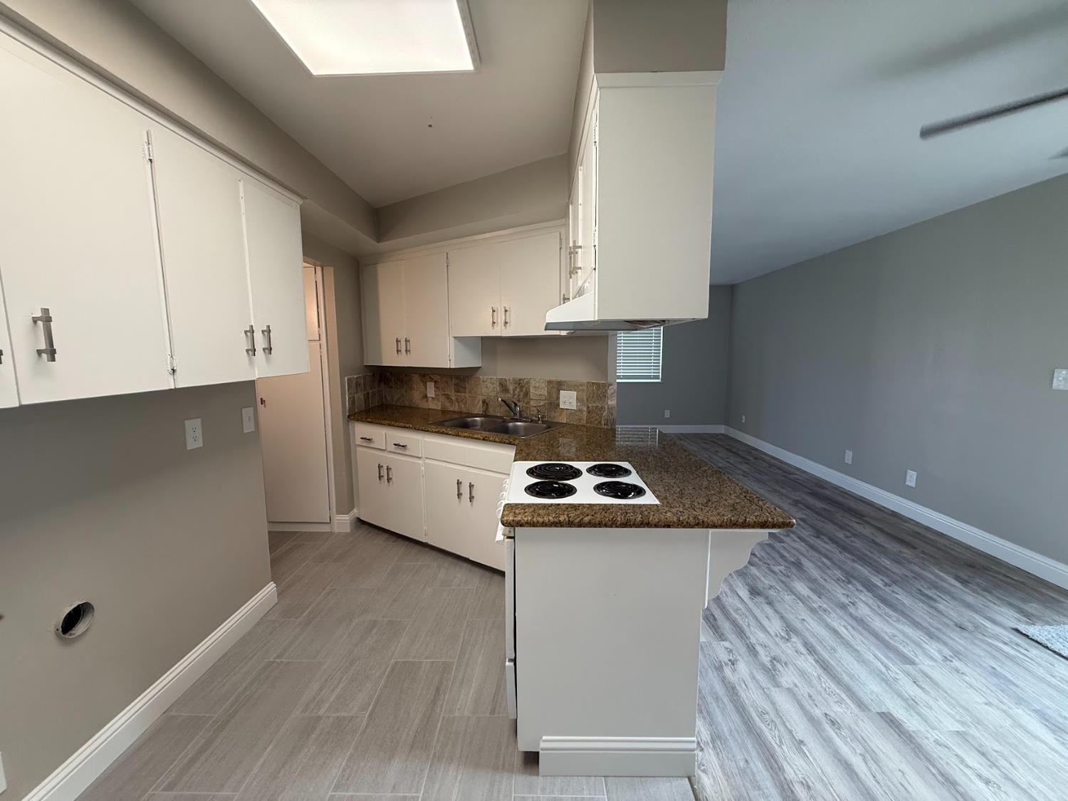 1205 F Street Reedley, CA 93654 - Photo 24 of 33 a kitchen with a sink a stove and cabinets