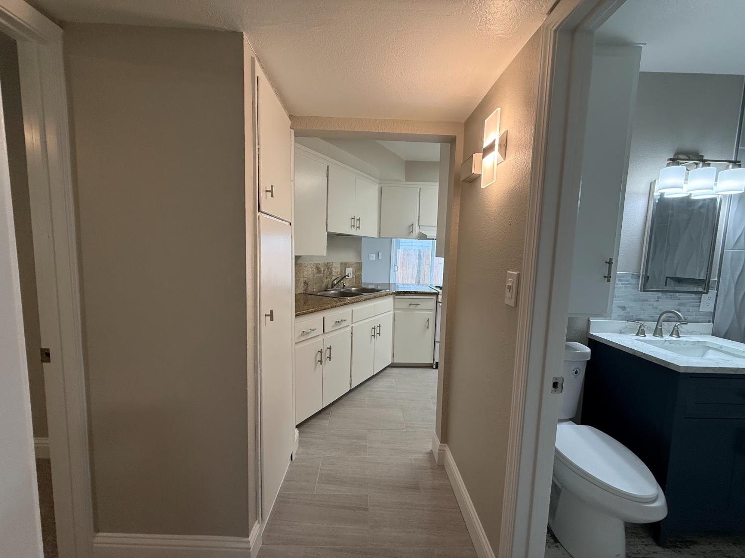1205 F Street Reedley, CA 93654 - Photo 25 of 33 a bathroom with a sink toilet vanity and mirror