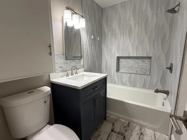 a bathroom with a sink toilet and shower