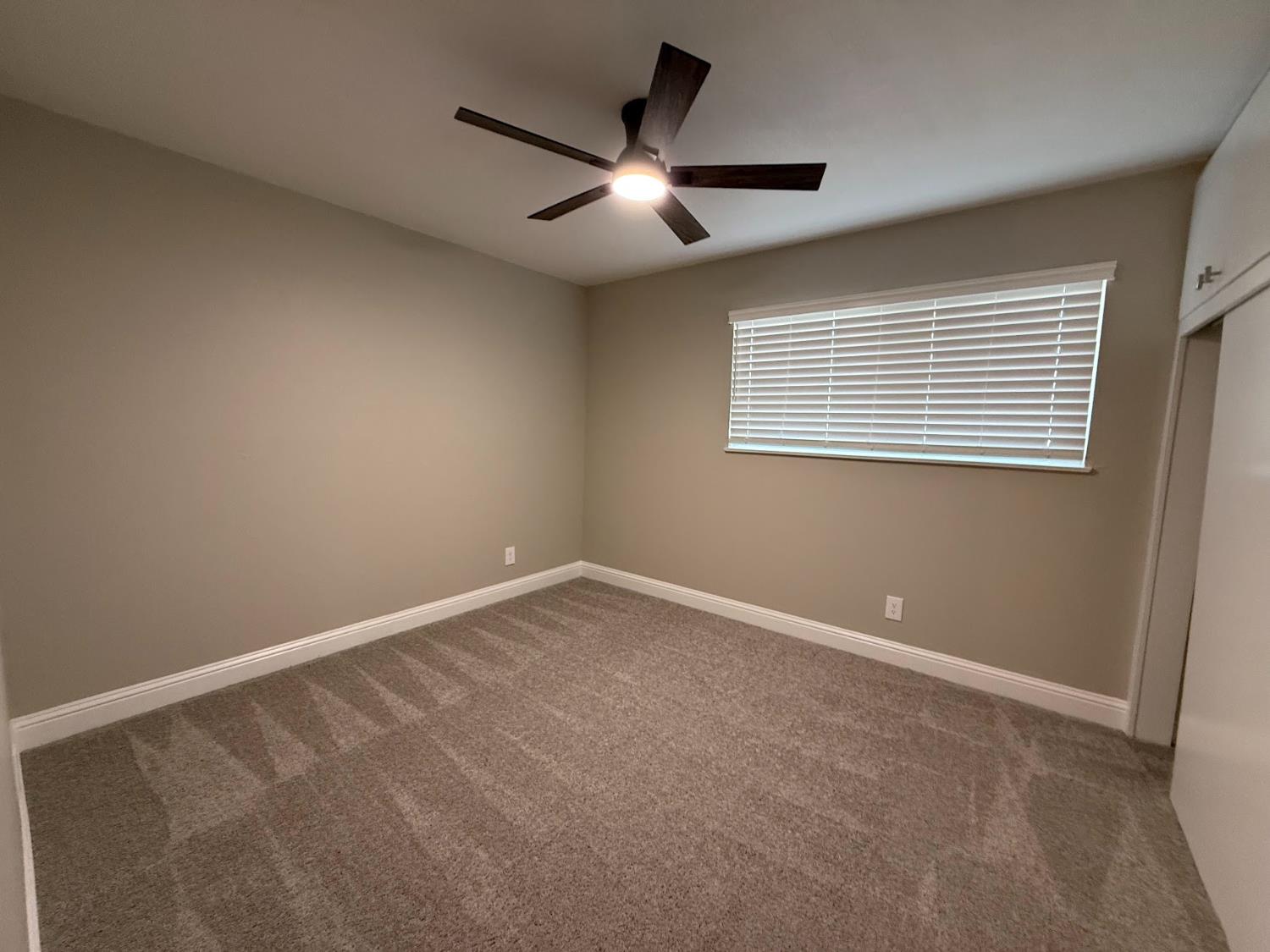 1205 F Street Reedley, CA 93654 - Photo 28 of 33 a view of an empty room with a window
