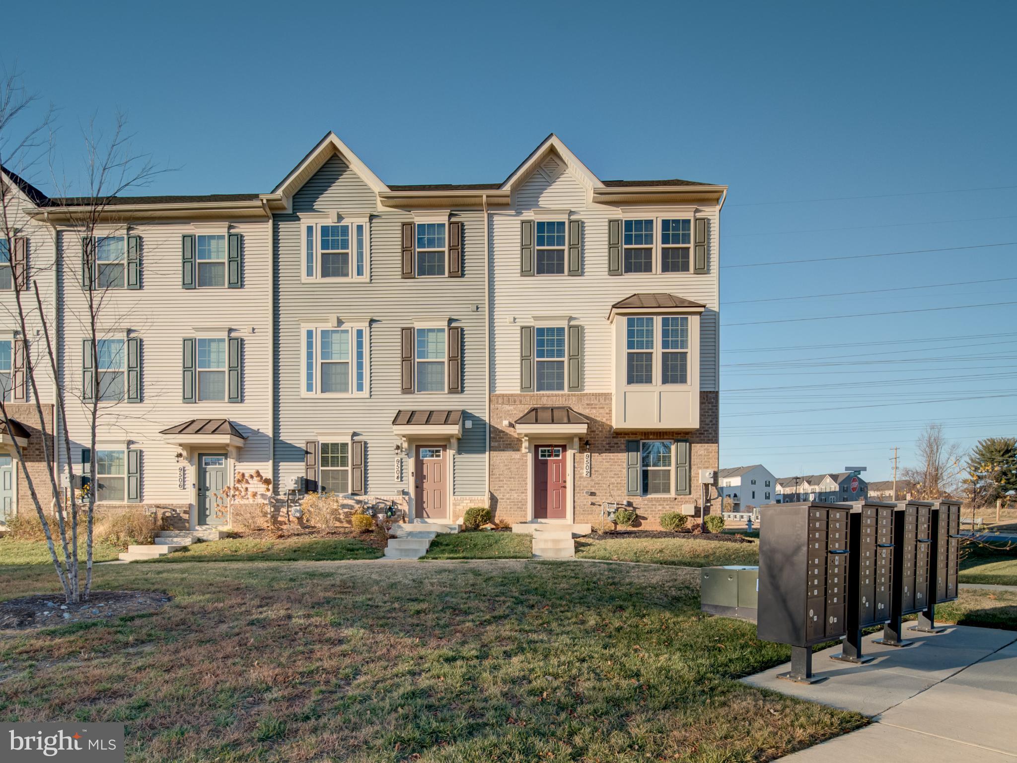 a front view of a residential apartment building with a yard