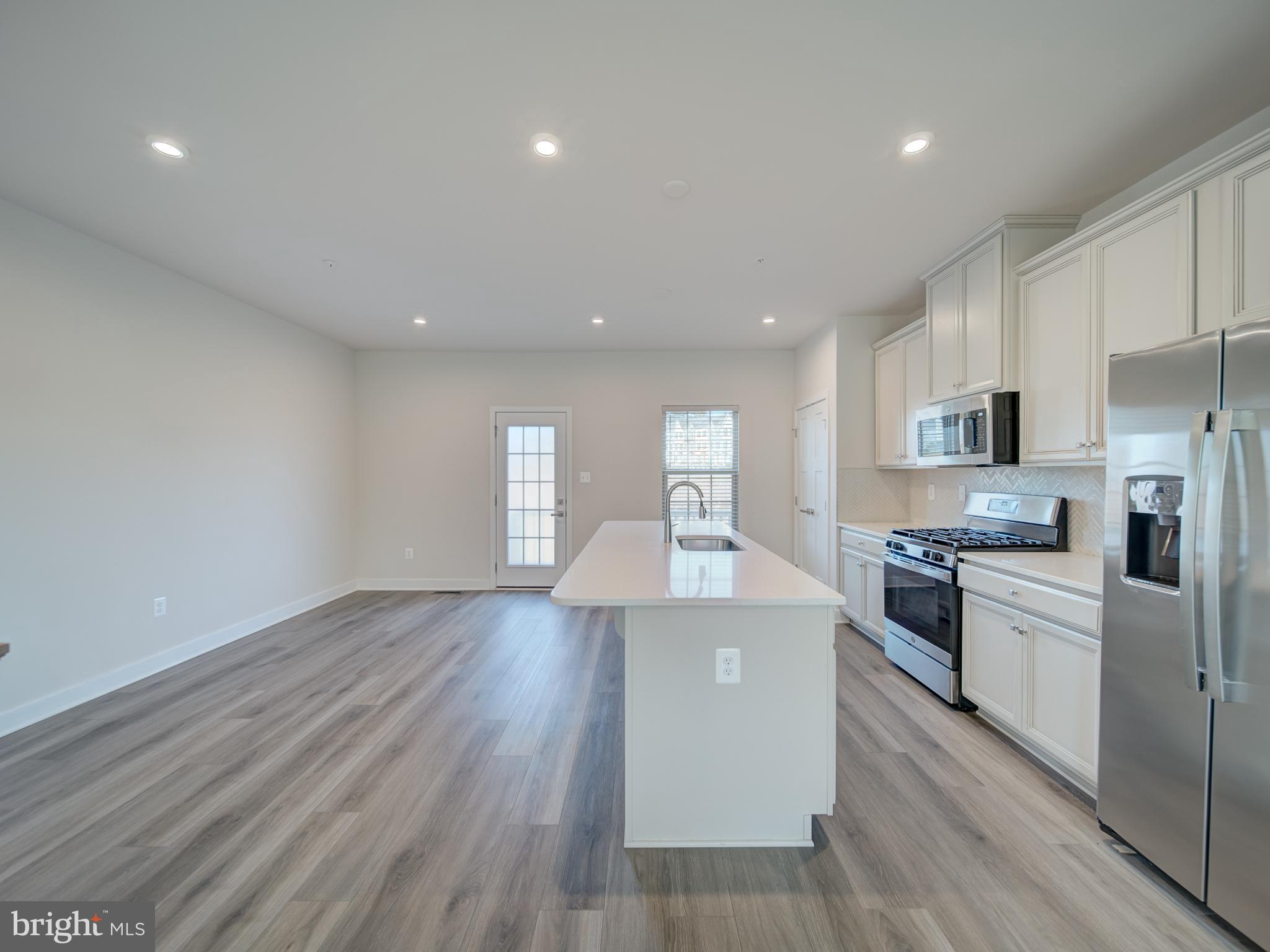 9502 Autumn Berry Place Montgomery Village, MD 20886 - Photo 12 of 36 a large kitchen with stainless steel appliances granite countertop a lot of cabinets and wooden floor