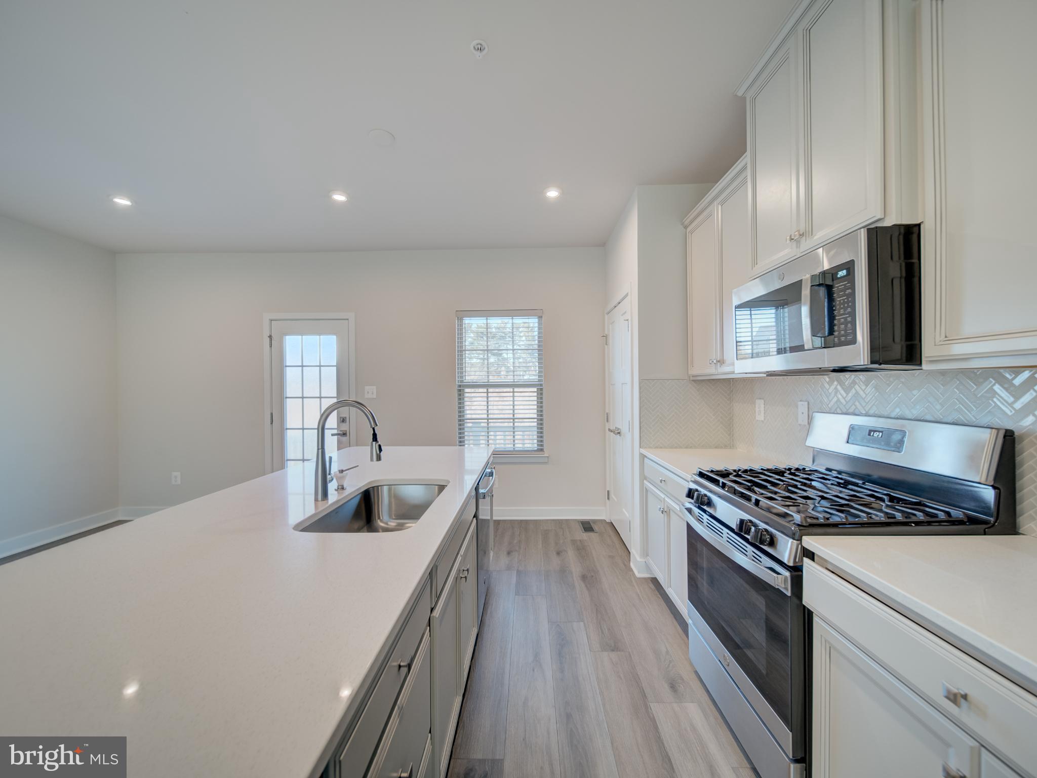 9502 Autumn Berry Place Montgomery Village, MD 20886 - Photo 14 of 36 a kitchen with granite countertop a sink stainless steel appliances and cabinets