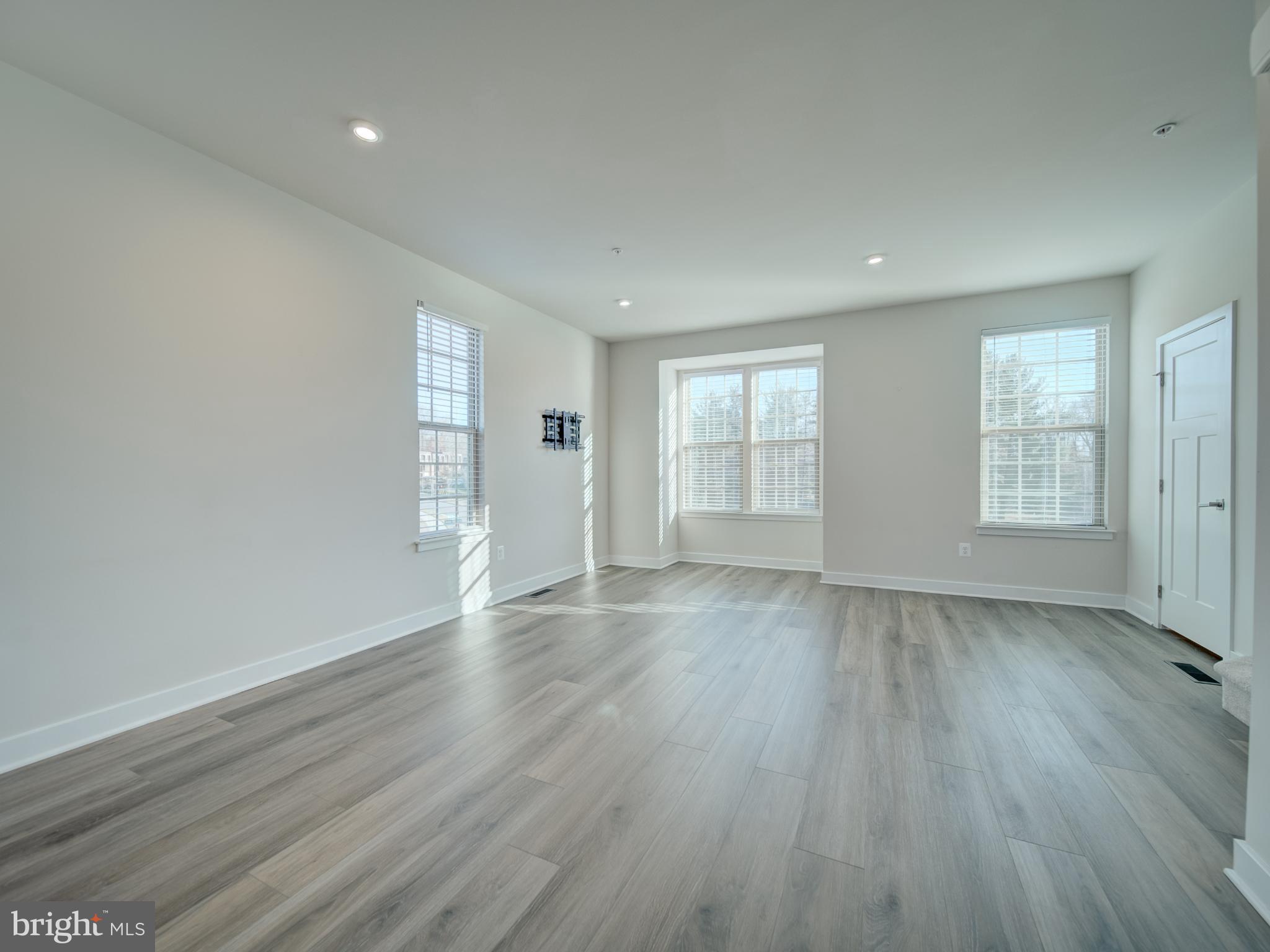 9502 Autumn Berry Place Montgomery Village, MD 20886 - Photo 19 of 36 an empty room with wooden floor and windows