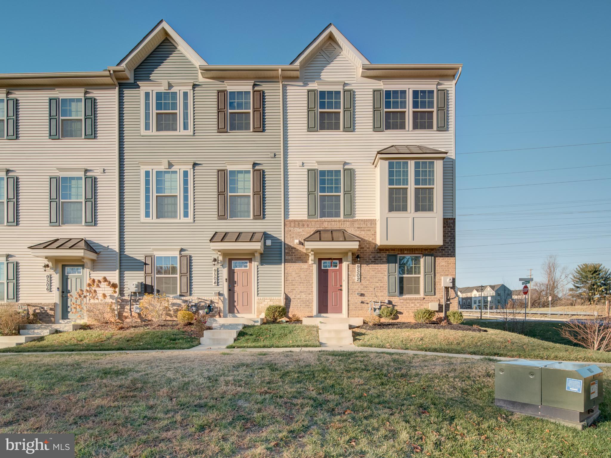 9502 Autumn Berry Place Montgomery Village, MD 20886 - Photo 2 of 36 a front view of a residential apartment building with a yard