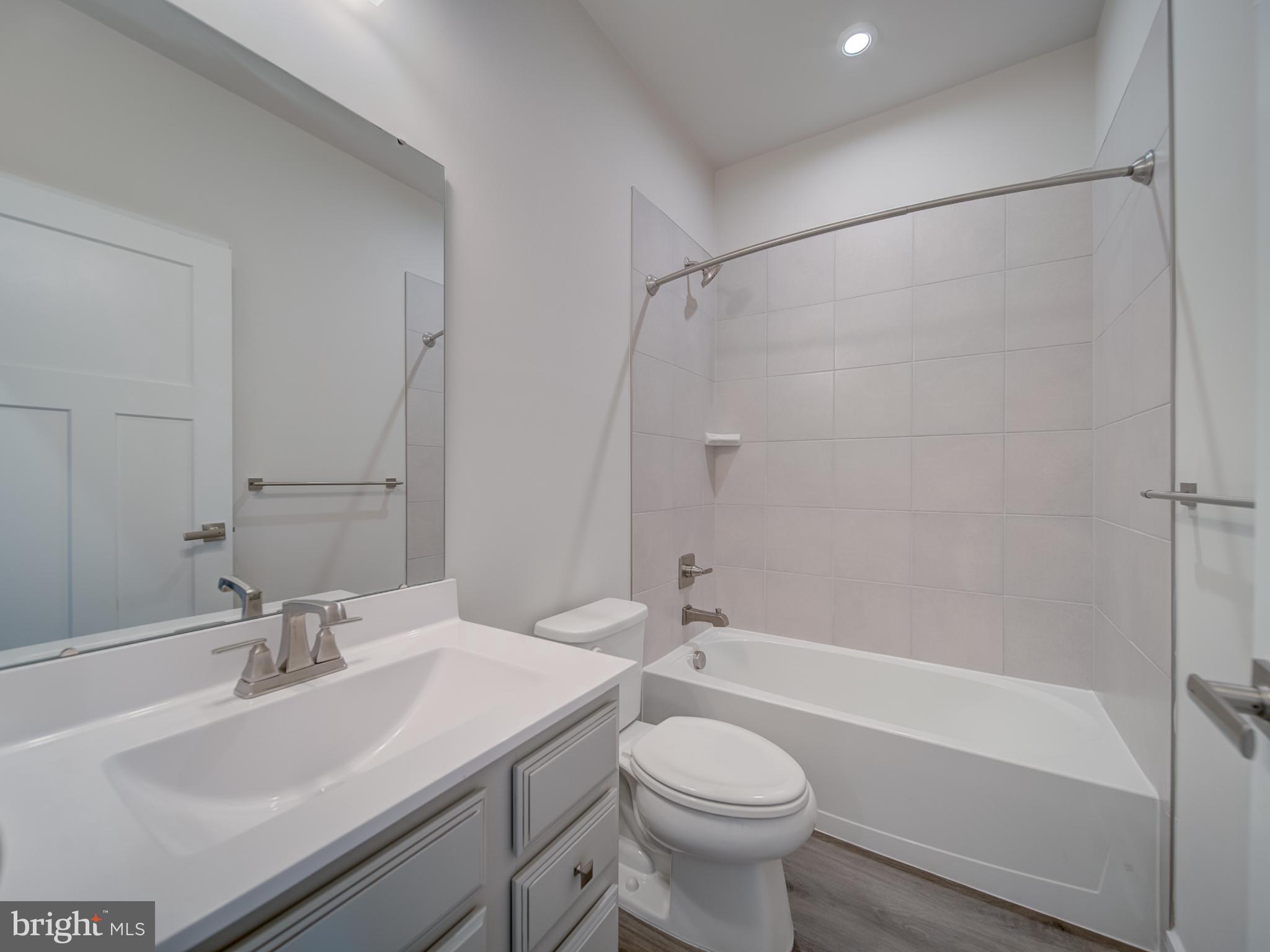 9502 Autumn Berry Place Montgomery Village, MD 20886 - Photo 23 of 36 a bathroom with a sink toilet and shower