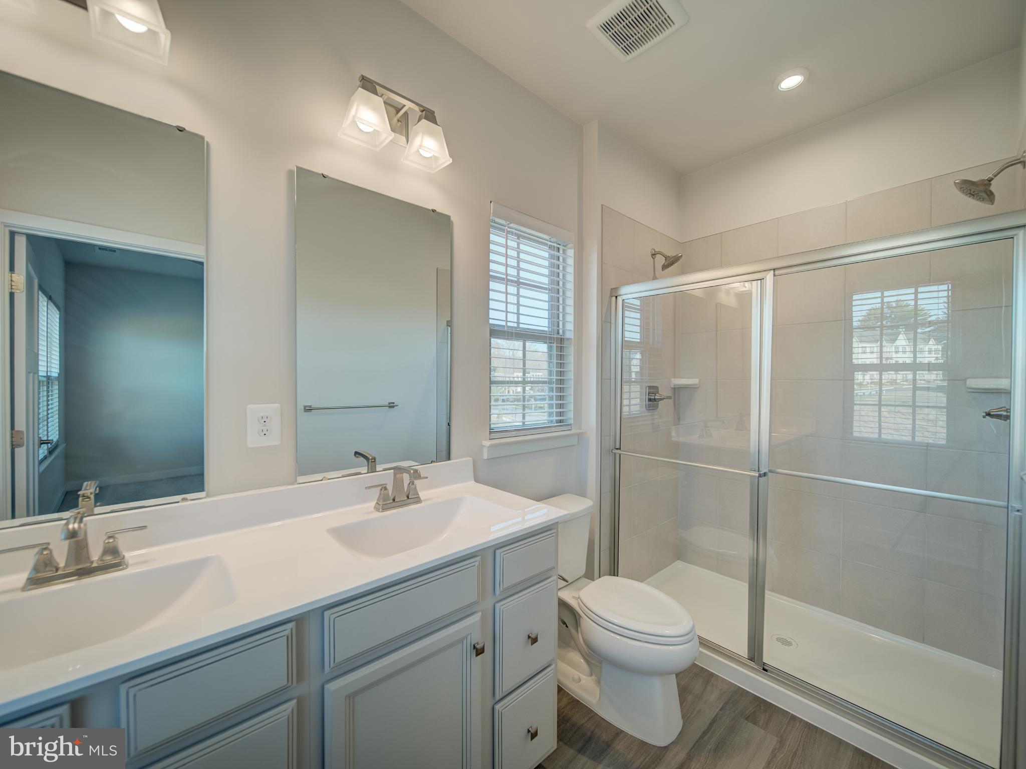 9502 Autumn Berry Place Montgomery Village, MD 20886 - Photo 27 of 36 a bathroom with a sink toilet and shower