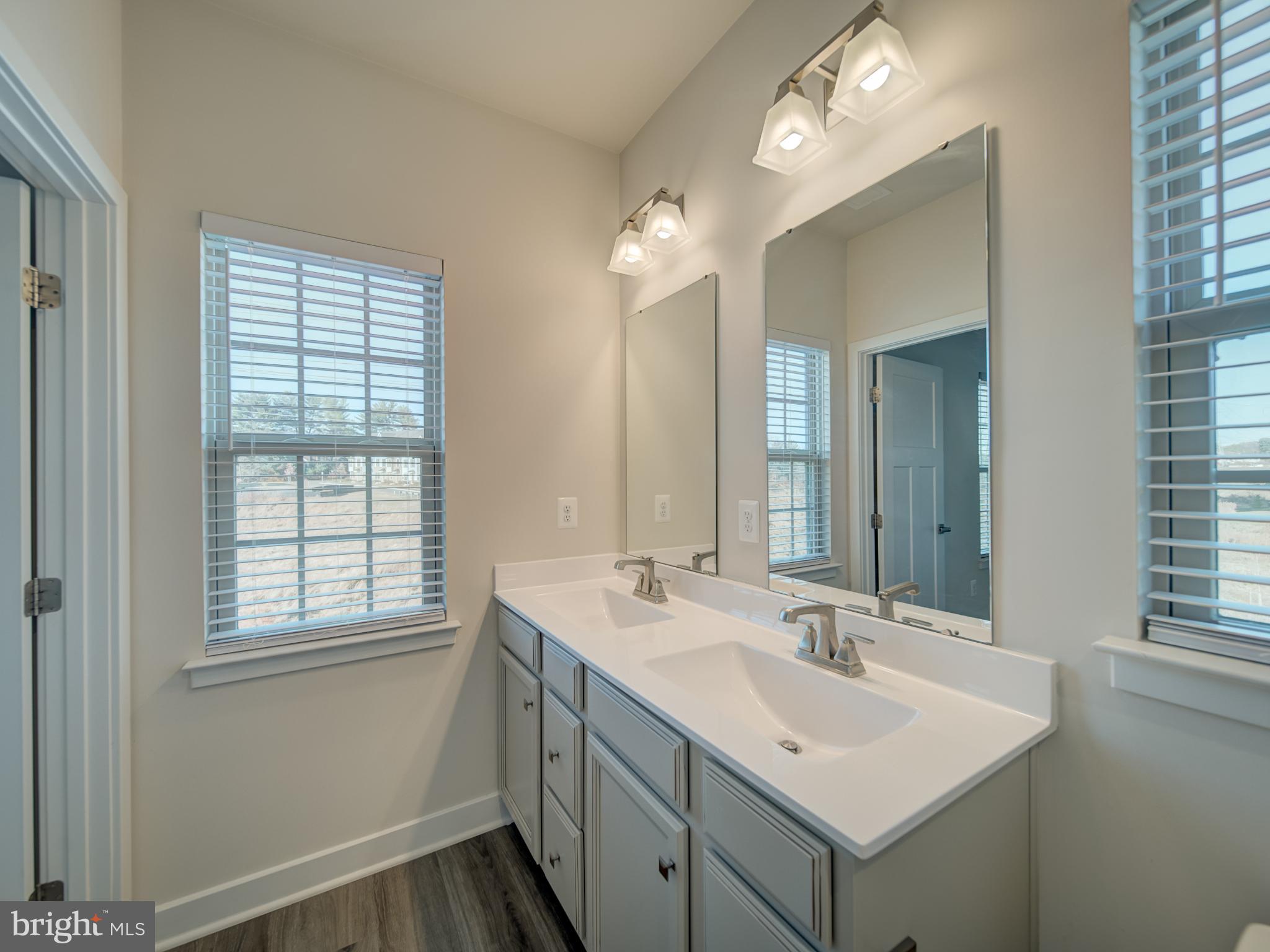 9502 Autumn Berry Place Montgomery Village, MD 20886 - Photo 28 of 36 a bathroom with a sink double vanity and a mirror