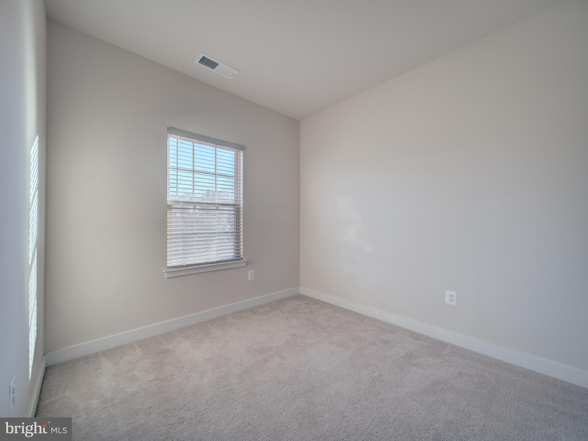 9502 Autumn Berry Place Montgomery Village, MD 20886 - Photo 32 of 36 an empty room with a window
