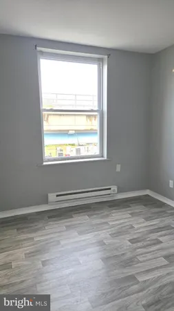 a view of an empty room and wooden floor