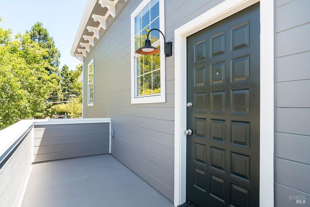a view of entry way with wooden door and windows
