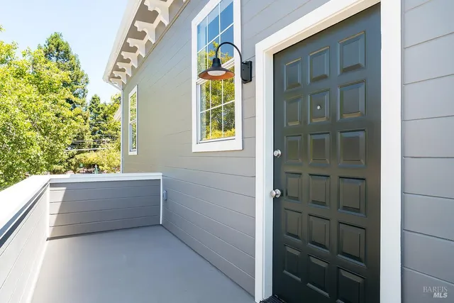 a view of entry way with wooden door and windows