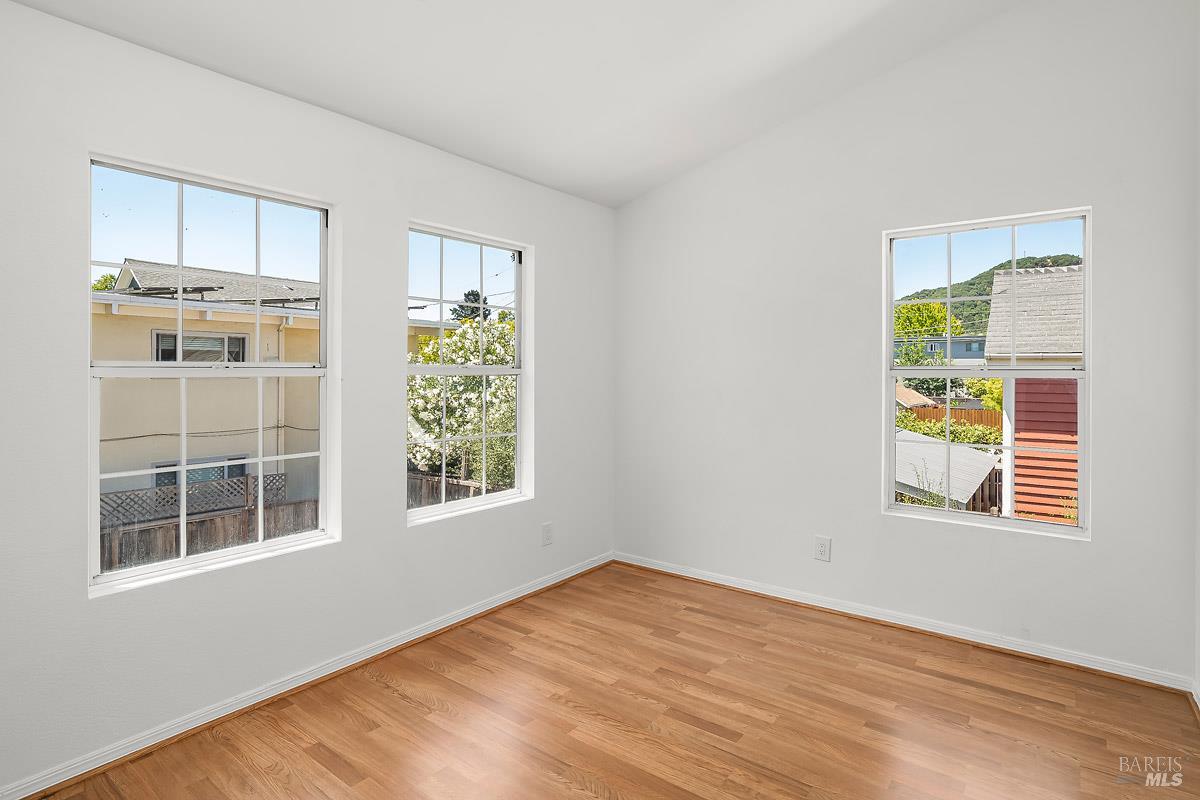 523 B Street San Rafael, CA 94901 - Photo 29 of 37 a view of an empty room with a window and wooden floor