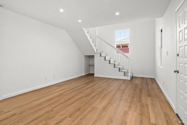a view of an entryway with wooden floor