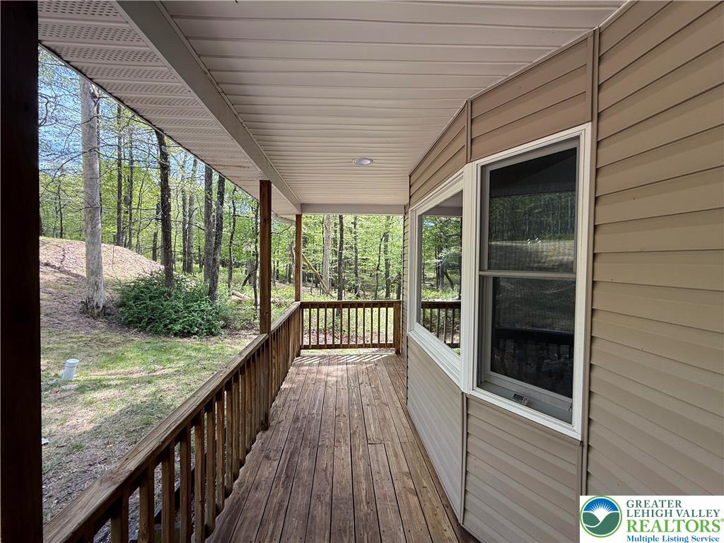 184 Doe Loop Bushkill, PA 18324 - Photo 4 of 18 a view of balcony with wooden floor