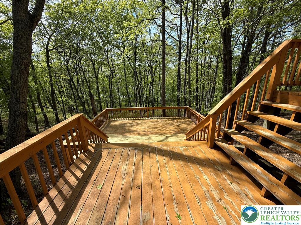184 Doe Loop Bushkill, PA 18324 - Photo 8 of 18 a view of swimming pool with seating area and trees