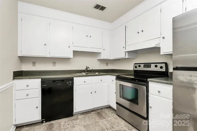 a kitchen with white cabinets and white appliances