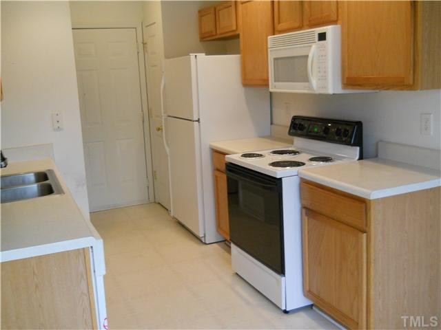 5510 Golden Moss Trail Raleigh, NC 27613 - Photo 6 of 16 Kitchen has refrigerator, electric stove, microwave and diswasher. Kitchen