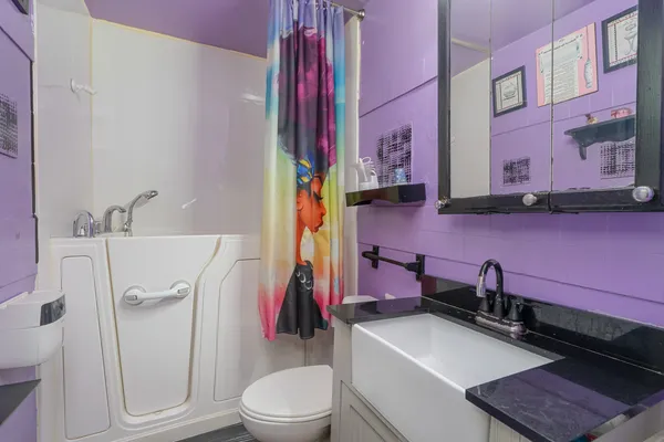 a bathroom with a sink a toilet and a tub