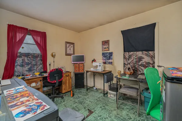 a reading room with furniture a rug and a window