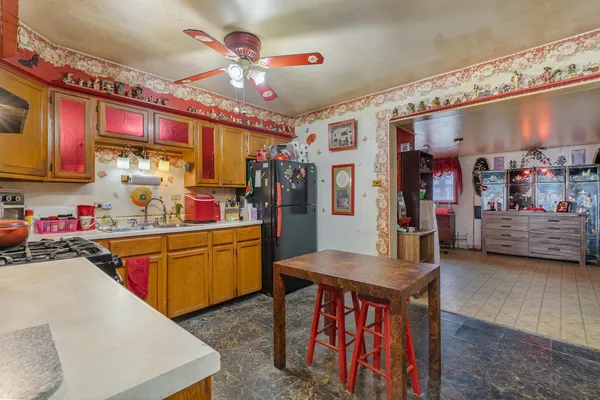 a kitchen that has a lot of cabinets and refrigerator