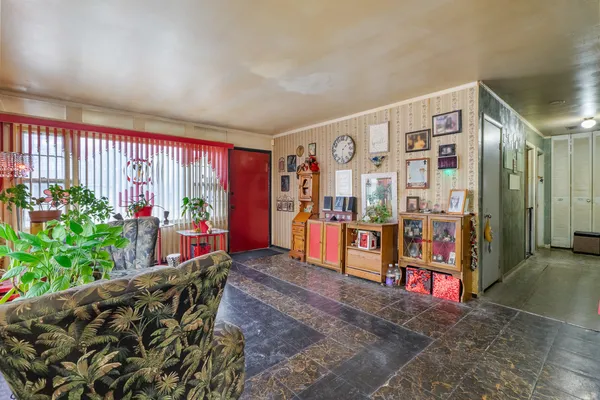 a living room with furniture and flowers