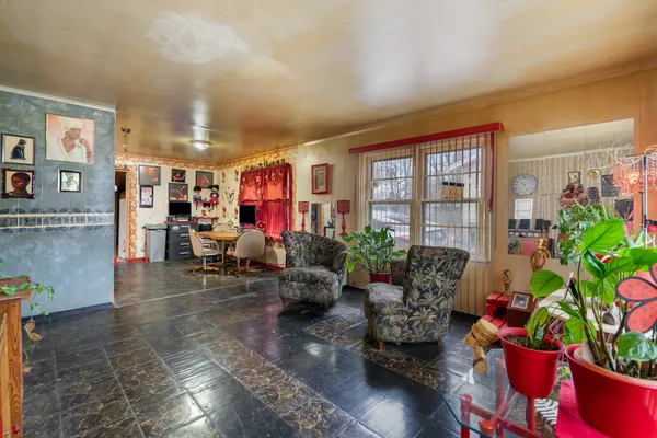 a living room with furniture and flowers