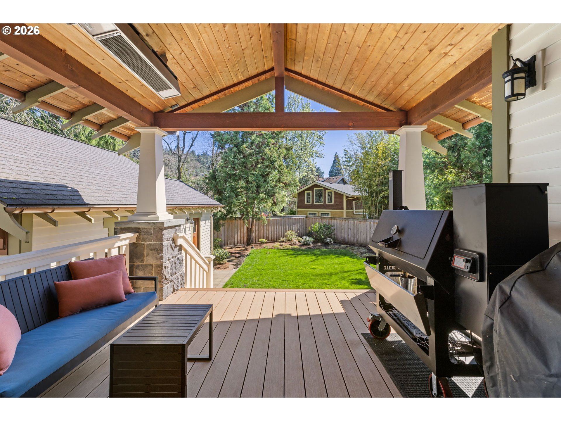 1030 Southeast 58th Place Portland, OR 97215 - Photo 14 of 48 a view of a patio with table and chairs under an umbrella with a barbeque grill and wooden floor