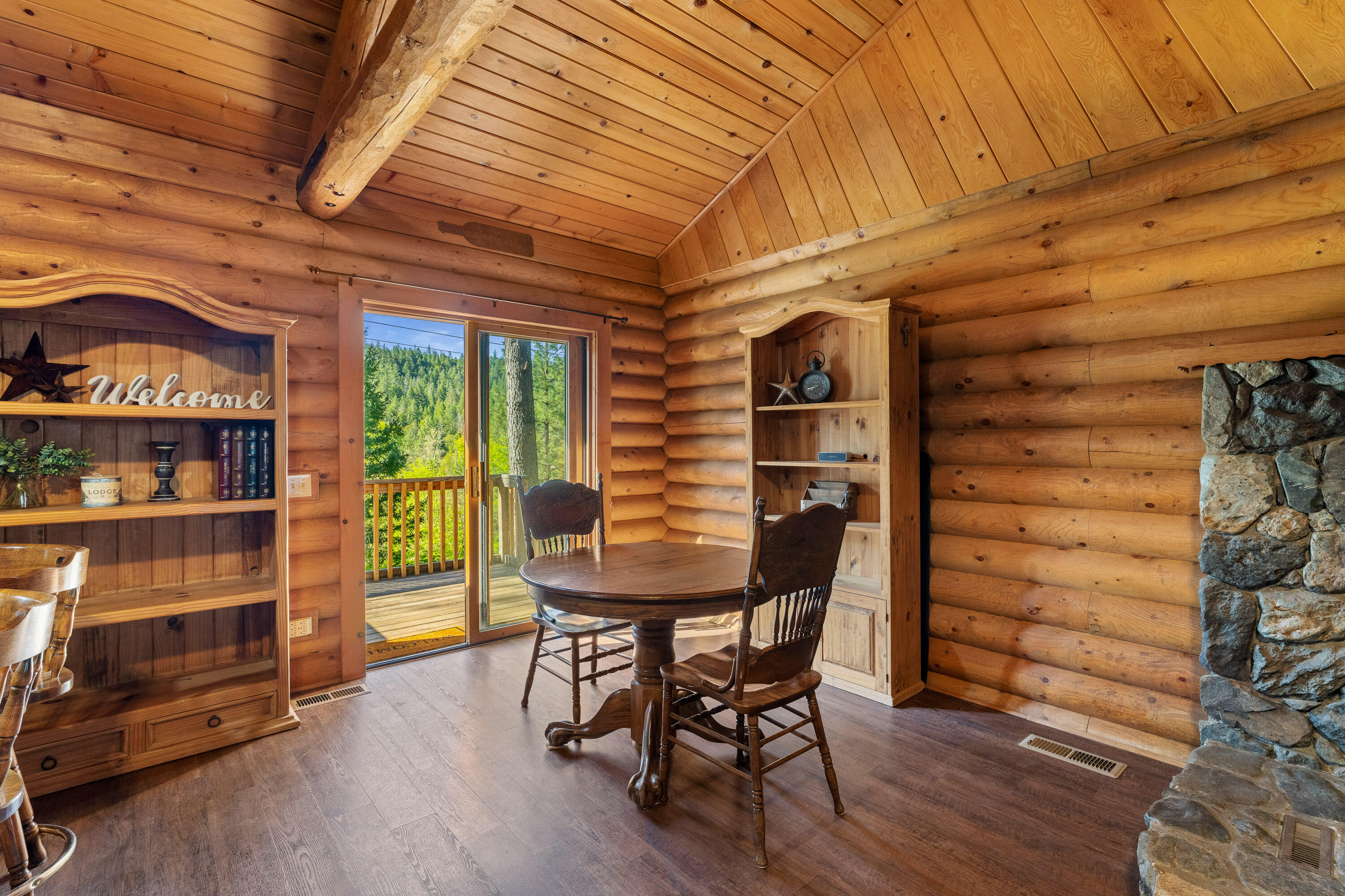 1201 Reeves Creek Road Selma, OR 97538 - Photo 10 of 38 a view of a dining room with furniture and wooden floor