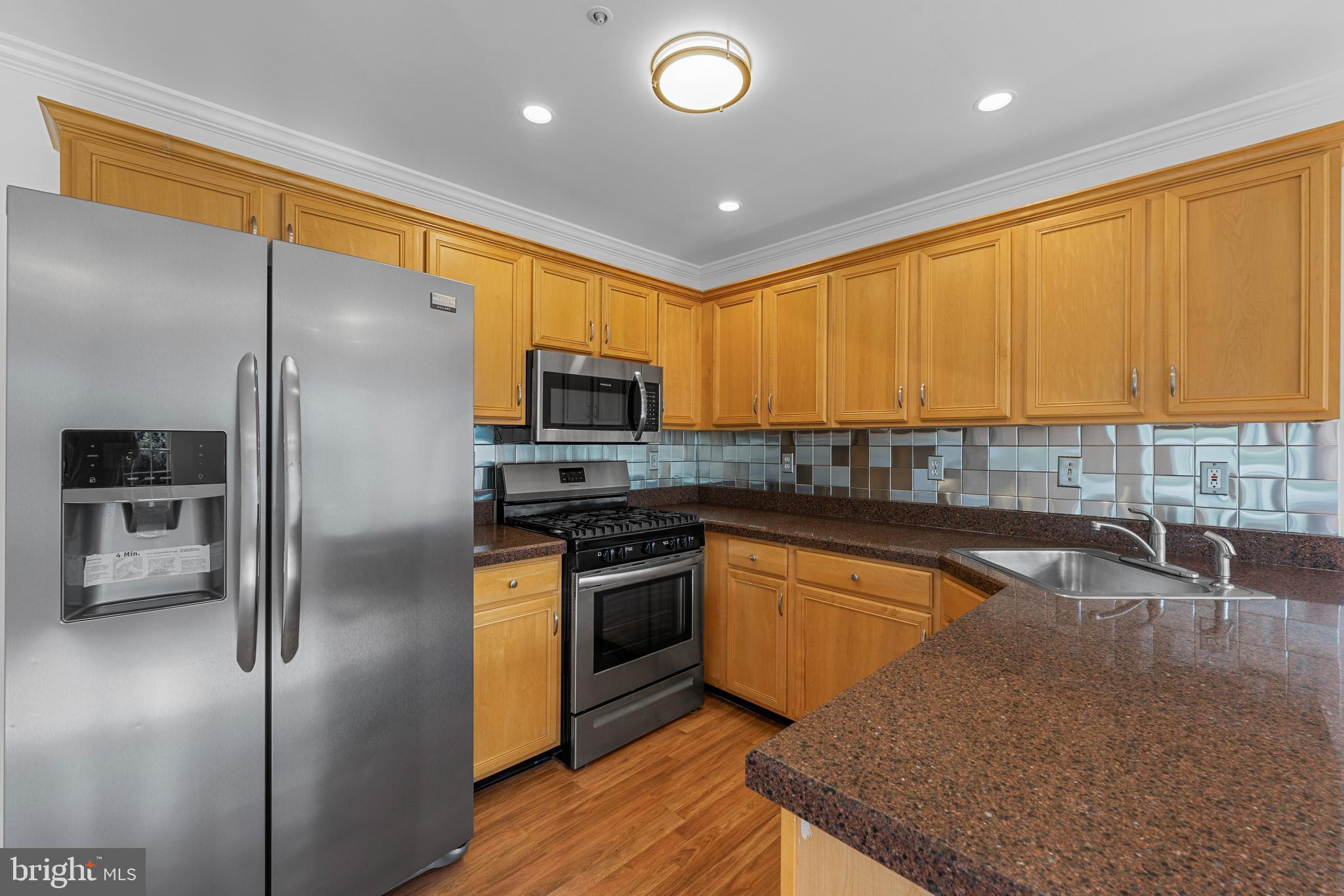 540 Eagle Court Jamison, PA 18929 - Photo 5 of 32 a kitchen with stainless steel appliances granite countertop a sink a stove and a refrigerator