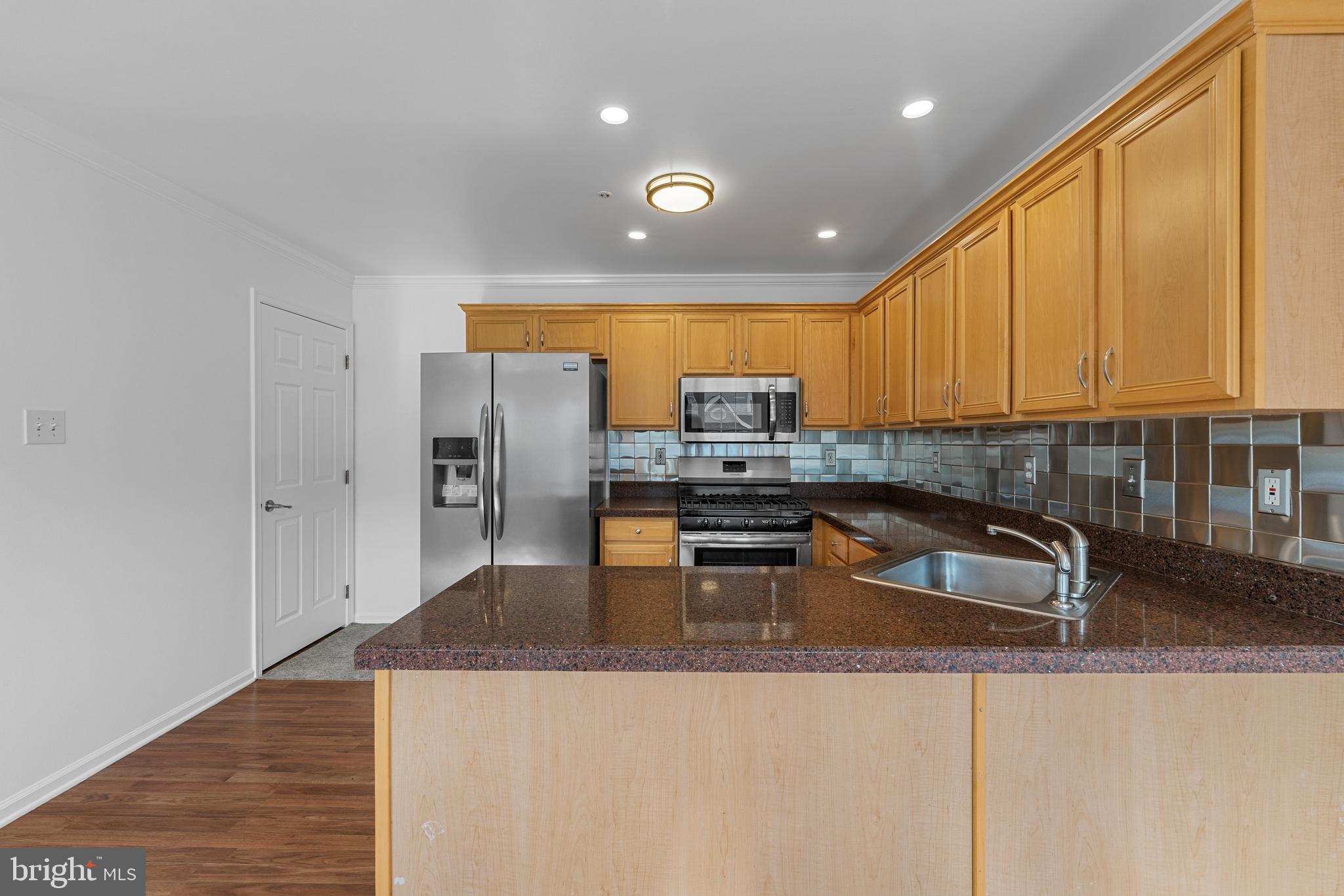 540 Eagle Court Jamison, PA 18929 - Photo 9 of 32 a kitchen with stainless steel appliances granite countertop a sink a stove and a refrigerator