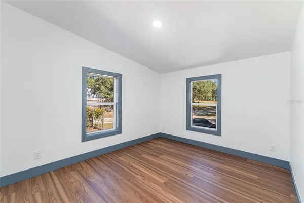 an empty room with windows and closet
