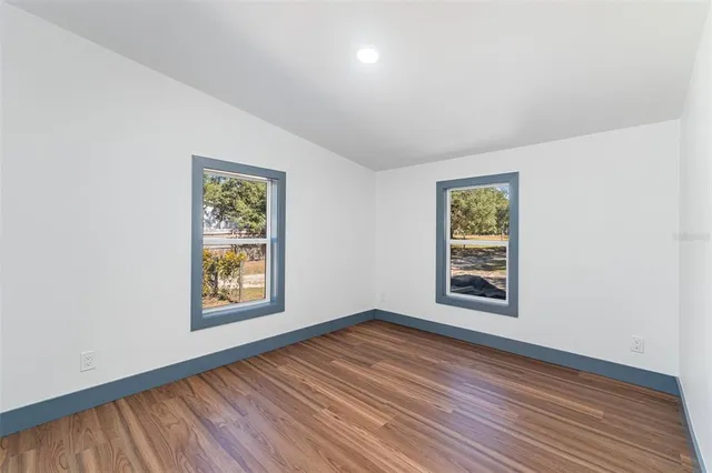 an empty room with windows and closet