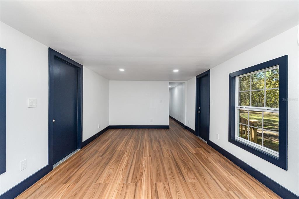 4664 Southwest 181st Court Dunnellon, FL 34432 - Photo 25 of 46 a view of an empty room with wooden floor and a window