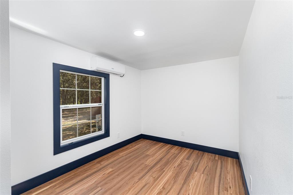 4664 Southwest 181st Court Dunnellon, FL 34432 - Photo 26 of 46 a view of empty room with wooden floor and fan