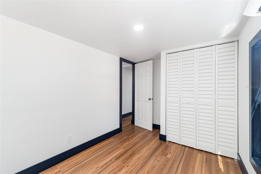 4664 Southwest 181st Court Dunnellon, FL 34432 - Photo 27 of 46 an empty room with wooden floor and white walls