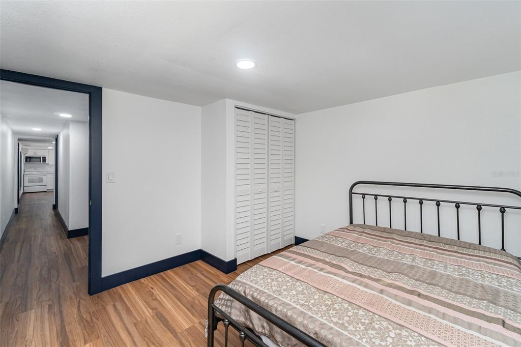 4664 Southwest 181st Court Dunnellon, FL 34432 - Photo 31 of 46 a bedroom with a bed and wooden floor