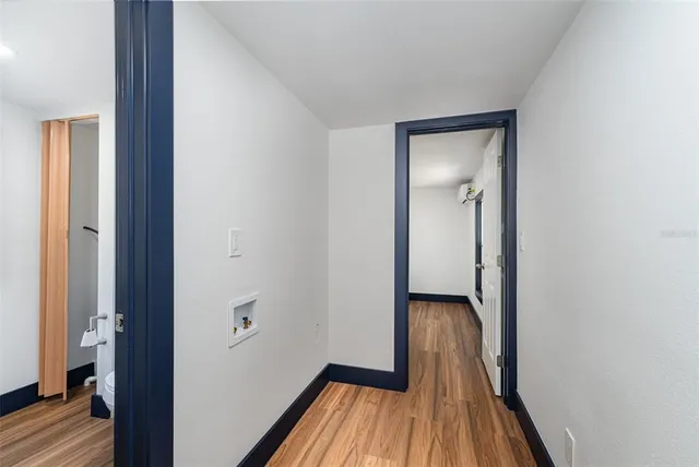 a view of a hallway with wooden floor