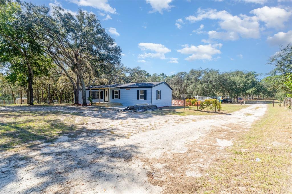 4664 Southwest 181st Court Dunnellon, FL 34432 - Photo 39 of 46 a view of a house with swimming pool and sitting area