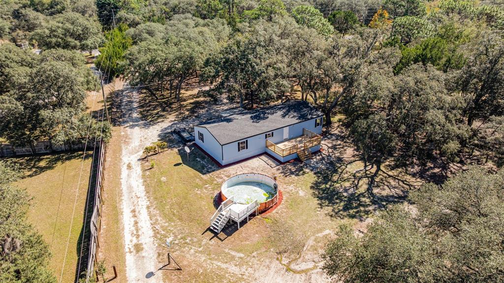 4664 Southwest 181st Court Dunnellon, FL 34432 - Photo 40 of 46 an aerial view of a house with swimming pool and large trees