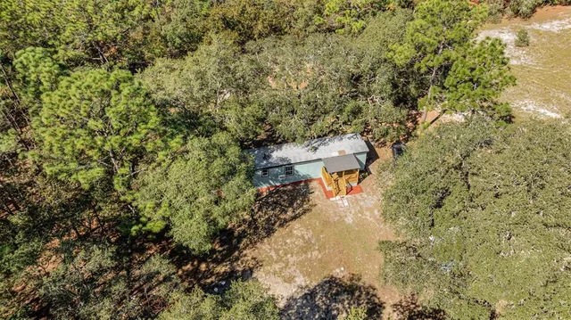a view of a wooden wall with trees in the background